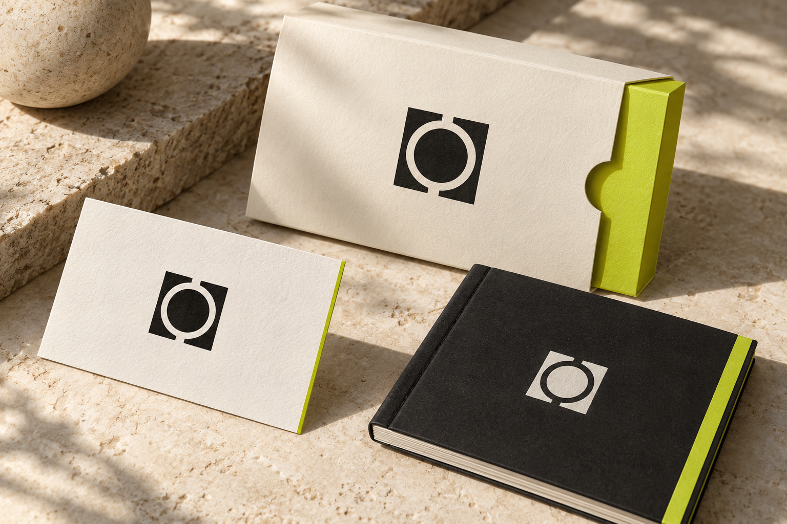 Minimal geometric logo applied to a card, packaging sleeve, and booklet